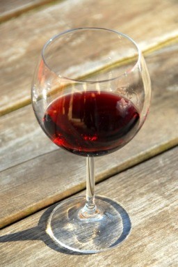 Glass of red wine on old rustic table