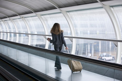 Business woman walking through airport