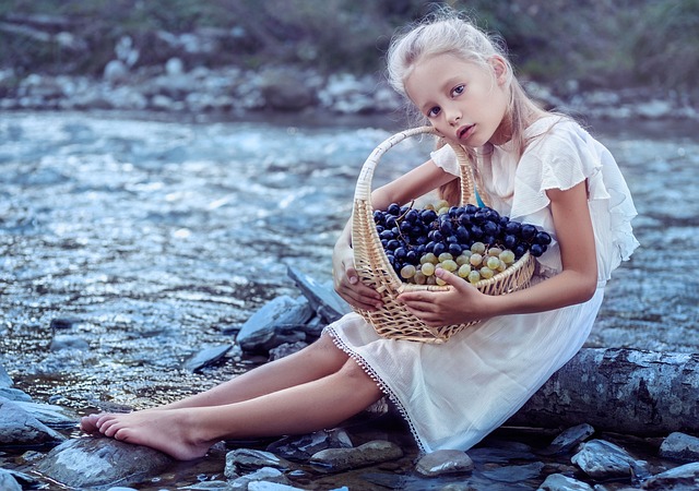 дете държи кошница с грозде